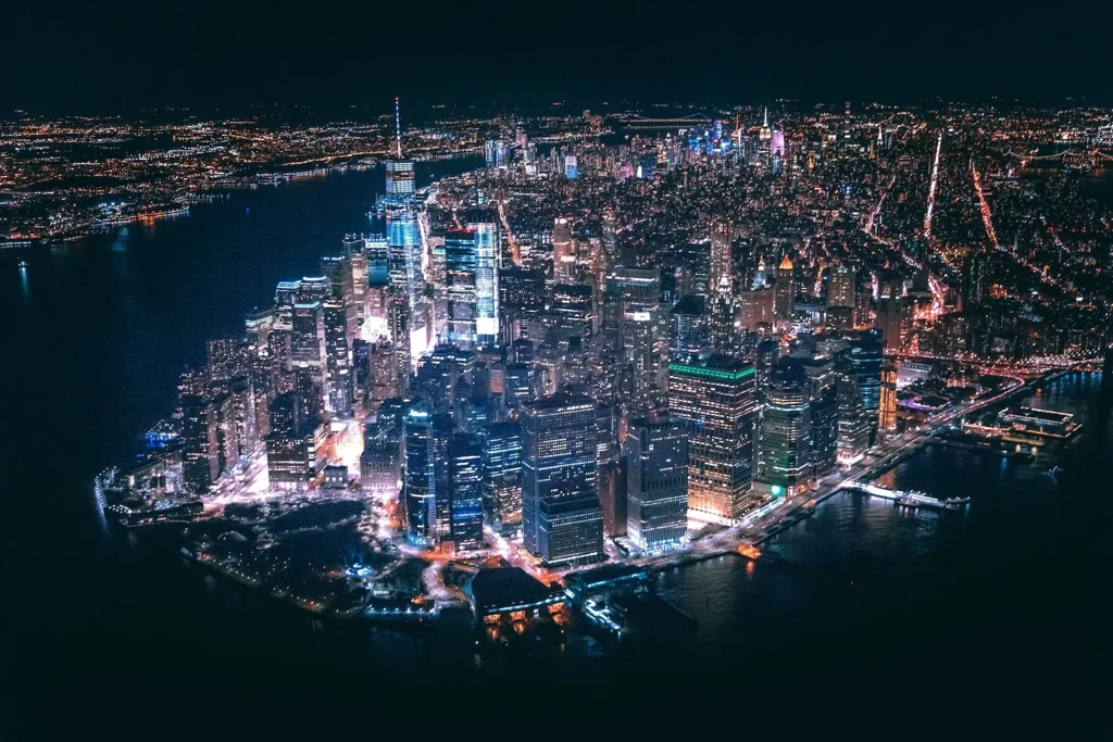 Lower Manhattan seen from the air at night, the financial district lit up